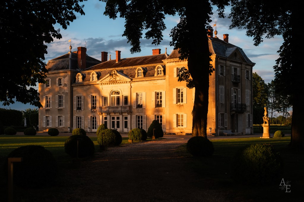 Golden hour chateau wedding venue in France with stone facade and gardens